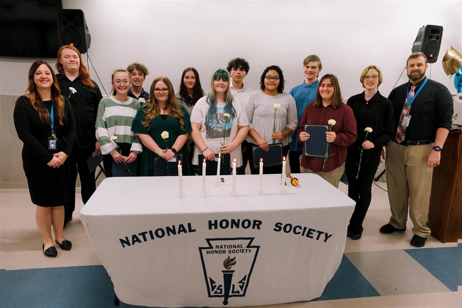  APW Principal Jennifer O’Malley and Vice Principal Tim LaRose stand with the newest NHS members. 